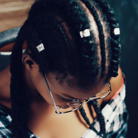 Person detangling hair with oil after braid removal