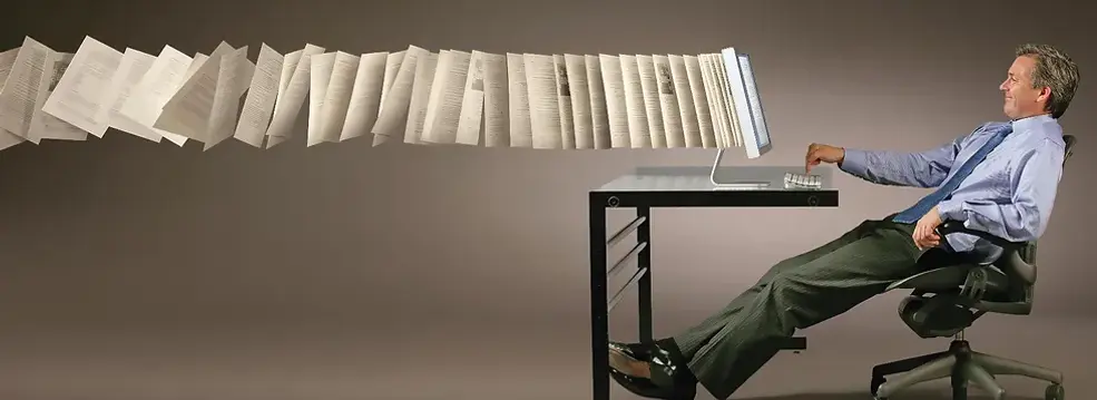 maximize-productivity-with-dman sitting at desk with a computer