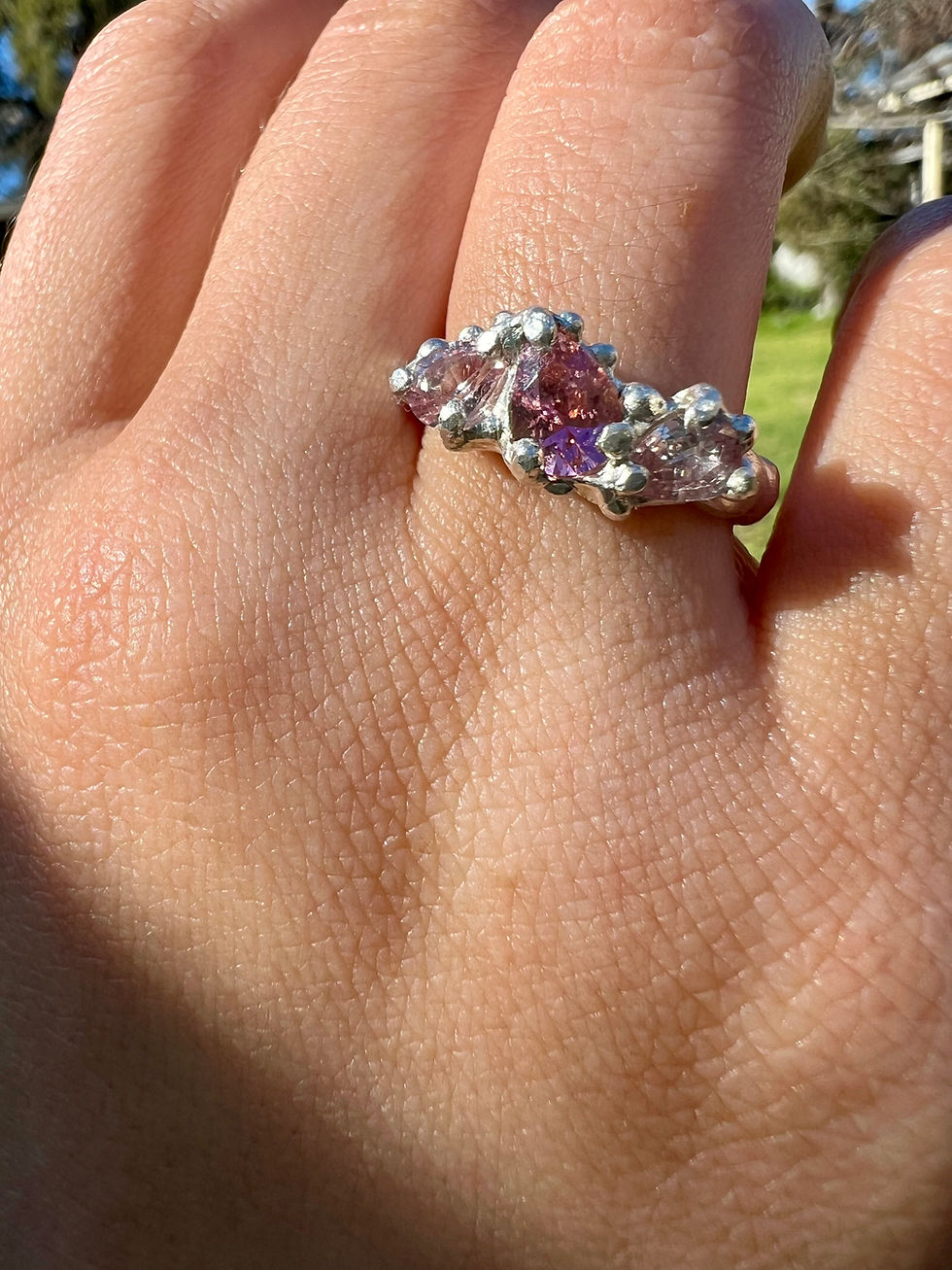 Thumbnail: Pink tourmaline and sapphire ring worn on hand, handmade by Jewel Sisters