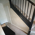 Limewash painting in wall and stairs banister on dark grey paint