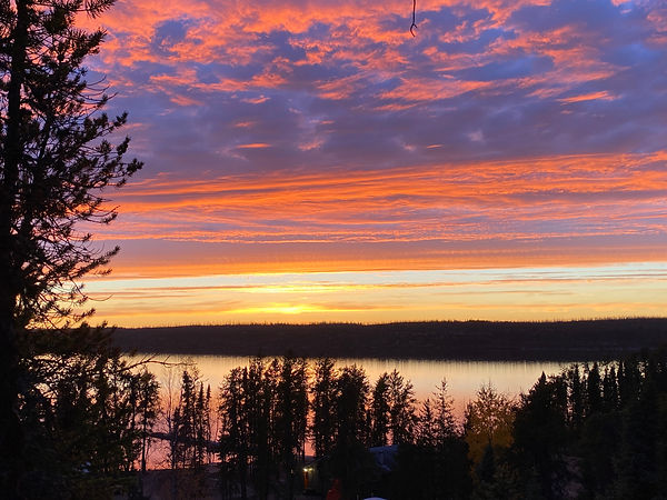 amazing orange and purple sunset overlooking camp from the rock face