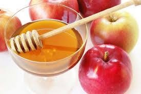 red apples and a bowl of honey