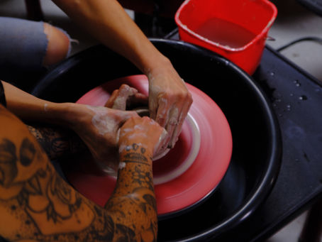 Ceramics students collaborating on a piece.