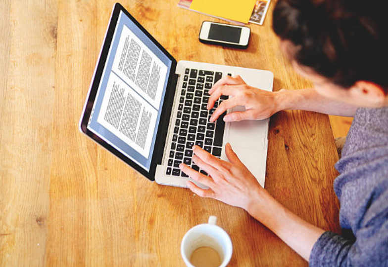 A lady writing something on the computer
