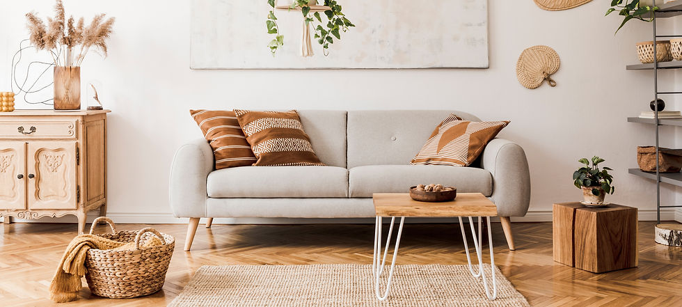 Cozy living room with a light gray couch, wooden furniture, and decor.