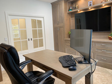 Minimalist office design featuring oak flat-panel cabinets, and integrated illuminated recessed display shelf and integrated cabinet pulls. Under-cabinet lighting. Full cable management with concealed wires.