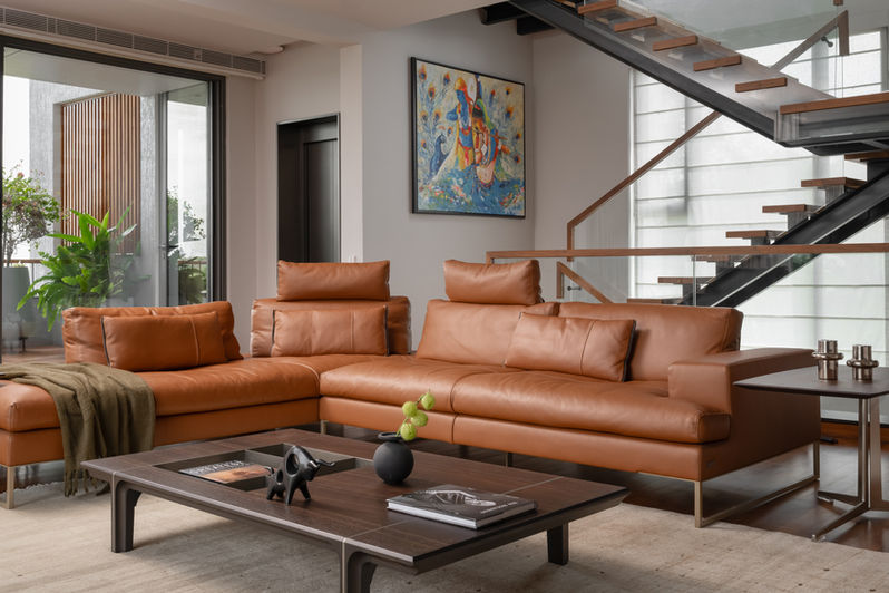 Elegant and Tasteful Living Room with bespoke tan leather sofa - Project Residence of Mr.Prasanth in Beverly Hills Bengaluru by Keystone Studio
