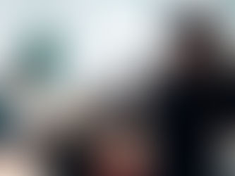 Young woman holding news camera to get footage of a group of people.