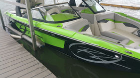 green jet boat at dock