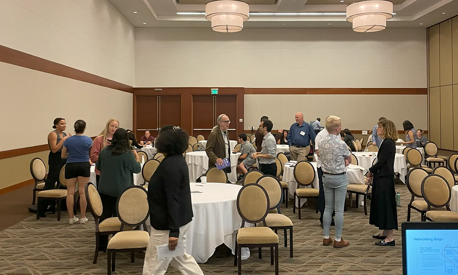 Attendees mingling during networking session.