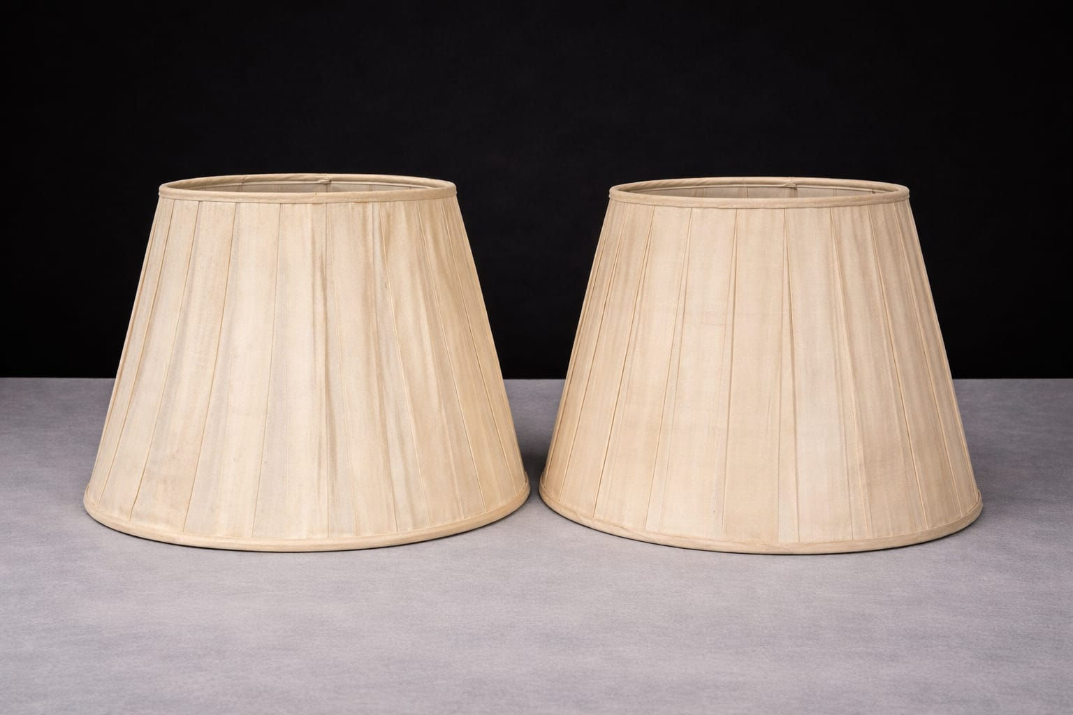 Pair of cream silk lampshades on brass and glass column table lamps