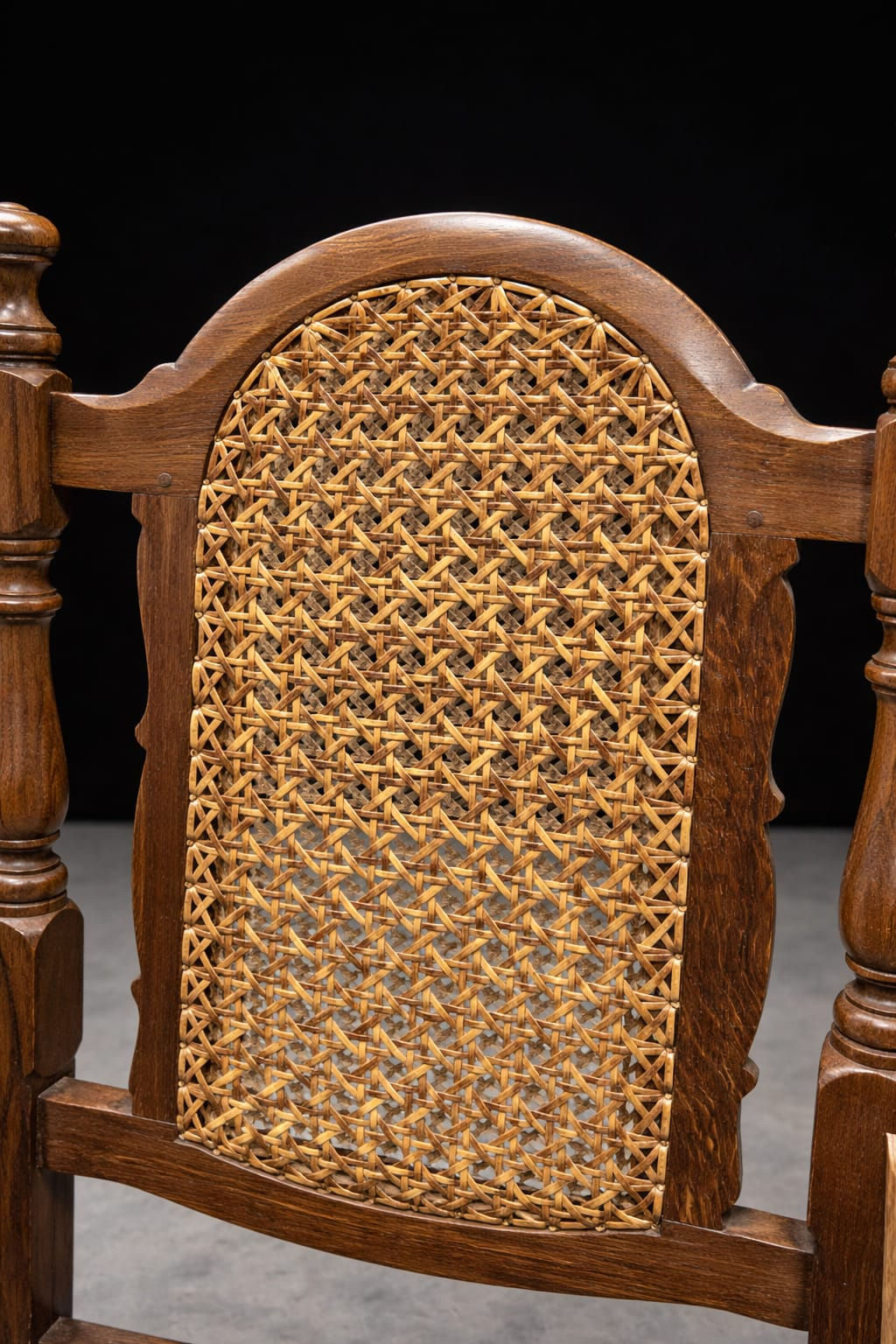 Cane backrest detail with arched oak frame