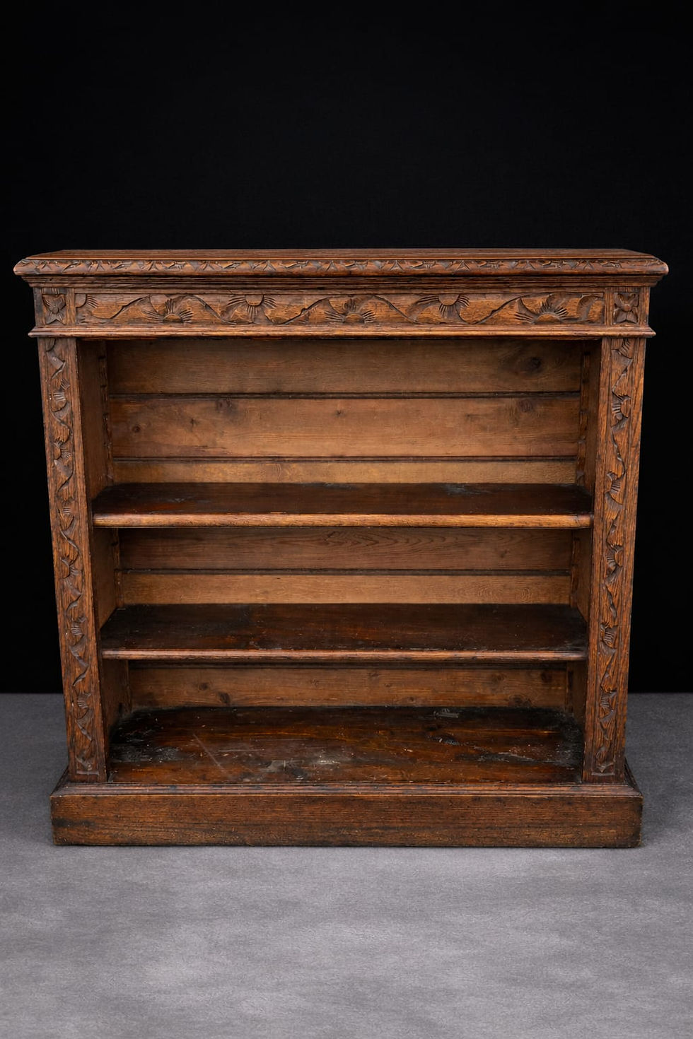 Antique oak open bookcase with carved frieze and adjustable shelves