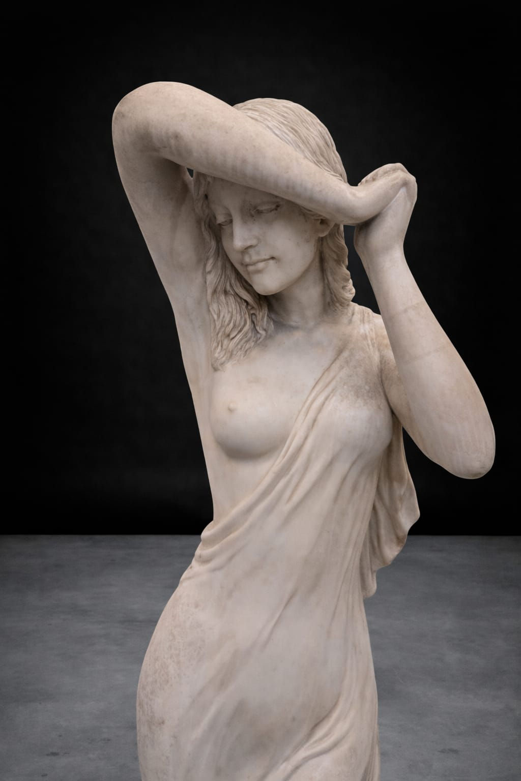 Detail of antique classical marble female figure sculpture showing flowing drapery and naturalistic anatomy, classical reviva