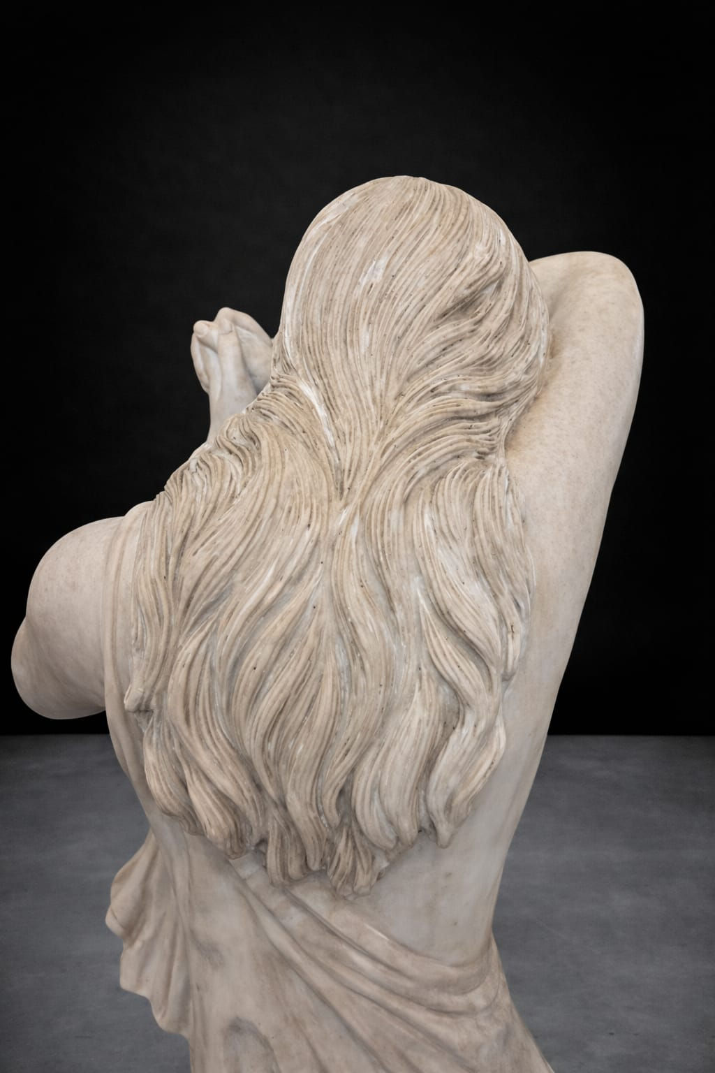 Back detail of antique classical revival marble statue showing carved hair and drapery, late 19th century female figure sculp