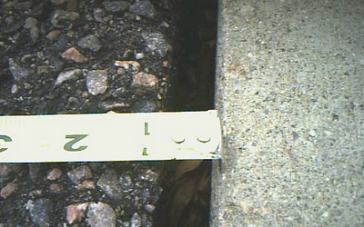 An example of pavement defect potentially hazardous to customers