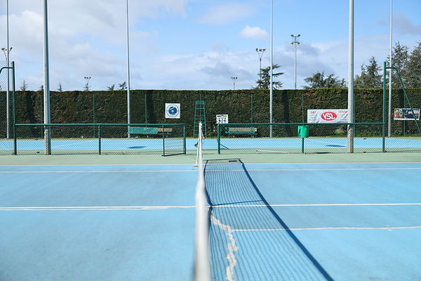 terrain de tennis bleu et ciel bleu filet