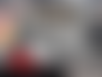 A writer seated at his desk with his computer screen showing a sentence that starts with a conjunction. He is looking at the huge Never Wall, which has writing myths carved on its front. A giant black wrecking ball emblazoned with the words "De-bunk da Bunk" is demolishing the Never Wall and the writing myths, e.g., bunk, once and for all.