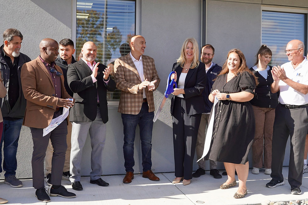 Warner Coin and Romeo Amusements team members, local legislators, and Erie Chamber representatives cutting the ribbon at the new shared office space.