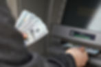 Stock image of someone receiving a deposit from an ATM machine as installed by Miele Group's Amusement Division