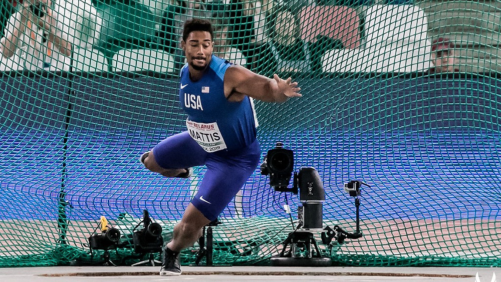Sam Mattis throws discus in international competition