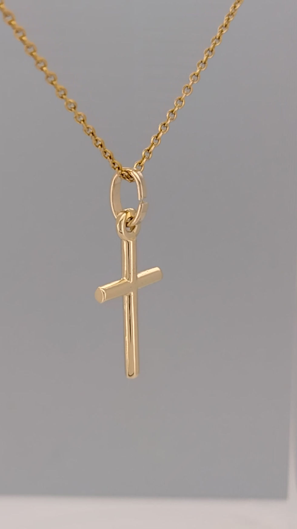 Thumbnail: Video preview of 9ct gold cross pendant against grey background