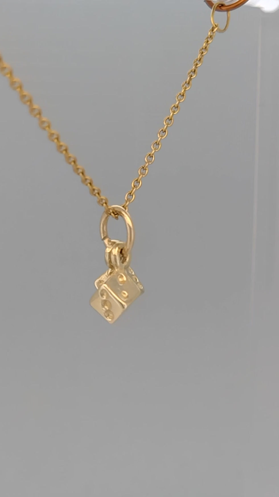 Thumbnail: Video 360-degree view of 9ct yellow gold dice pendant necklace on grey background