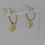 Thumbnail: Video showing 9ct gold heart charm huggie earrings against grey background.