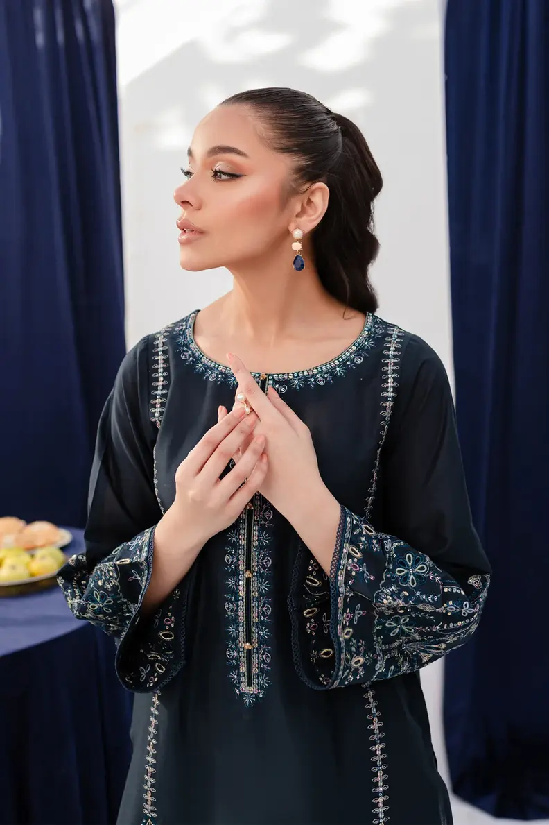 Model is wearing Pakistani brand Batik's Timber Blue Color Cotton Embroidered Co-Ord Set with a shirt & trouser