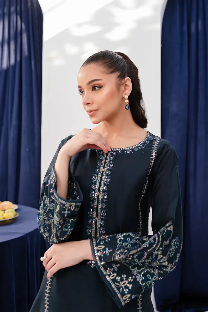 Model is wearing Pakistani brand Batik's Timber Blue Color Cotton Embroidered Co-Ord Set with a shirt & trouser