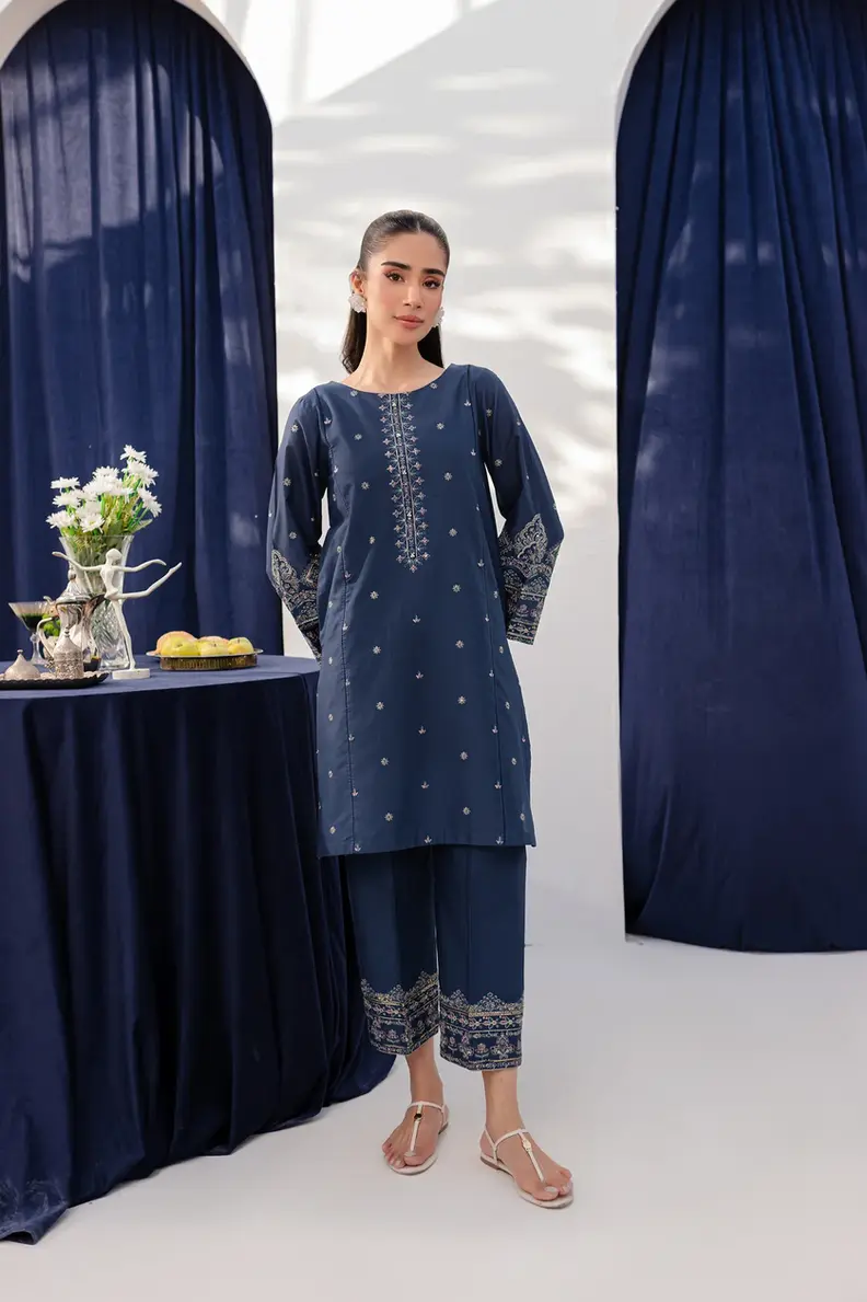 Model is wearing Pakistani brand Batik's Deep Blue Cotton Embroidered Co-ord Set with a shirt & trouser
