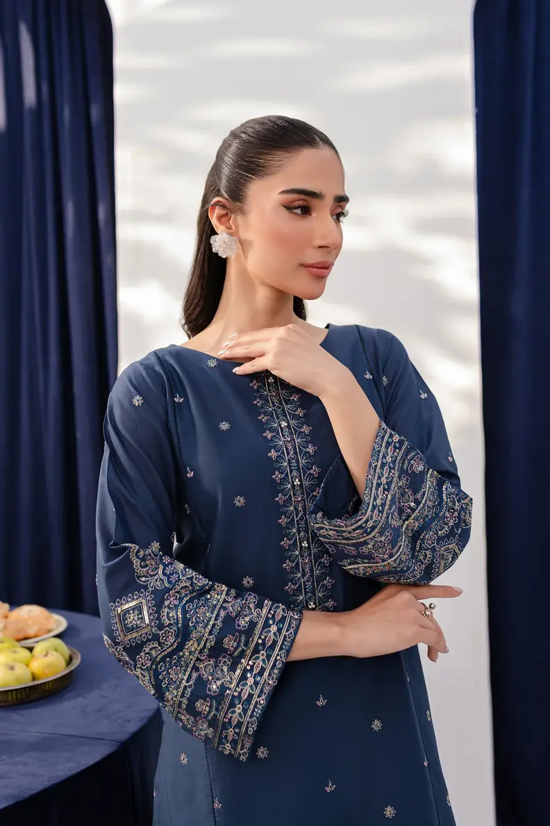 Model is wearing Pakistani brand Batik's Deep Blue Cotton Embroidered Co-ord Set with a shirt & trouser