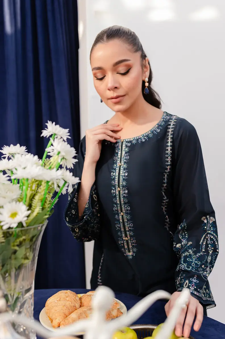 Model is wearing Pakistani brand Batik's Timber Blue Color Cotton Embroidered Co-Ord Set with a shirt & trouser