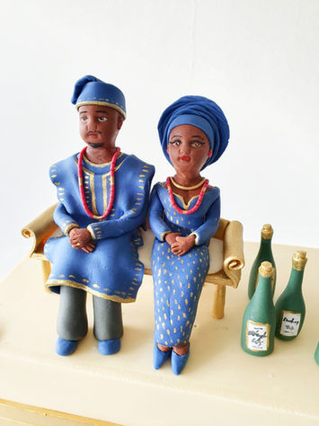 Yoruba engagement bride and groom cake toppers in traditional attire.