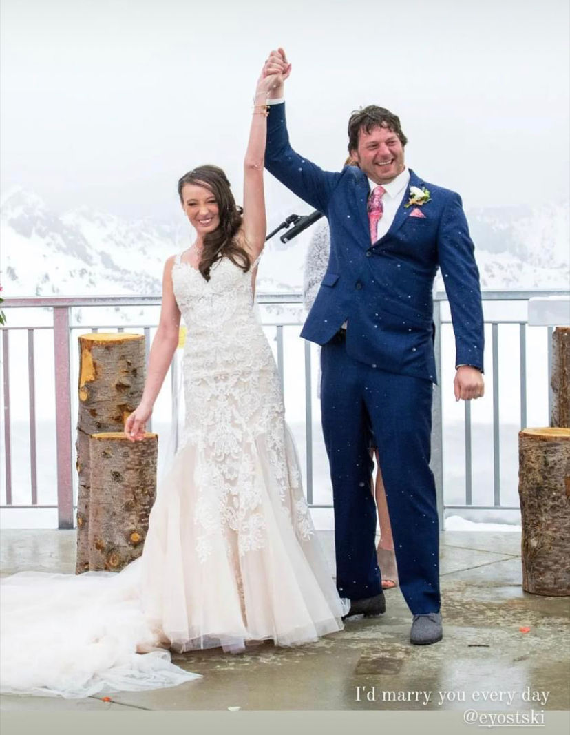 a bride and groom are celebrating their wedding at Snowbird Ski Resort