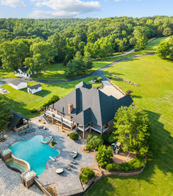 drone photography over pool and large estate 