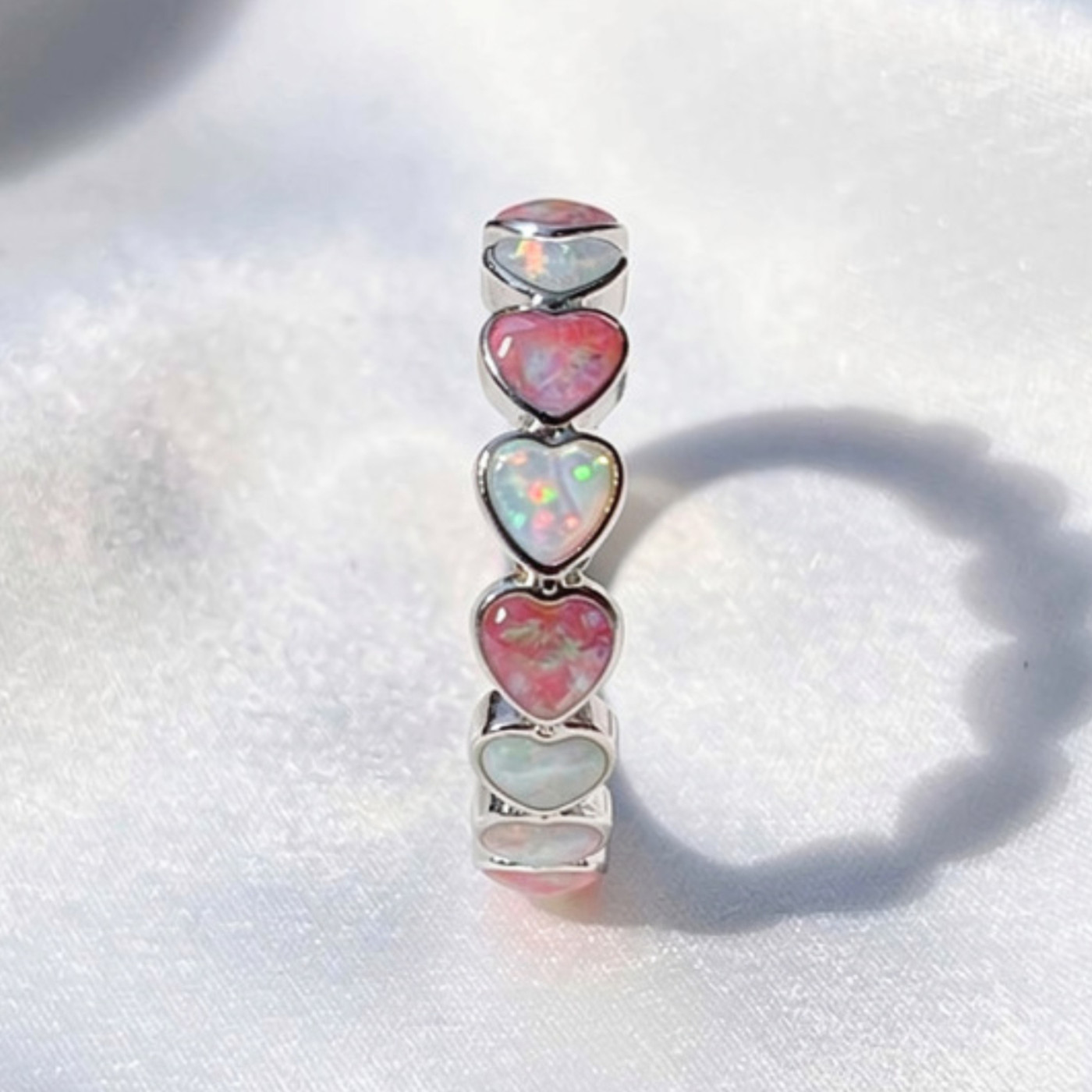 Eternity ring featuring crushed opal and ash inlay.