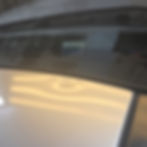 big dent on roof of car near windshield.