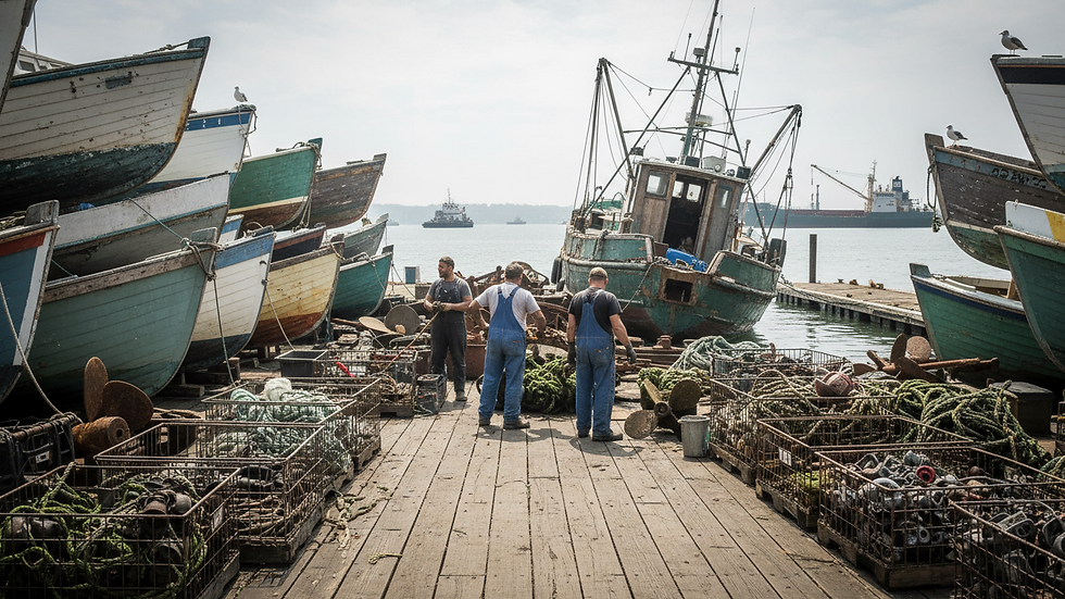 Eye-level view of a marine salvage yard with stacked boat hulls and parts