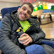 A Swadlincote male service user, holding his water bottle and smiling for the camera on a