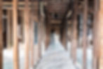 Historic New Orleans house under renovation showing original wood framing and long central hallway