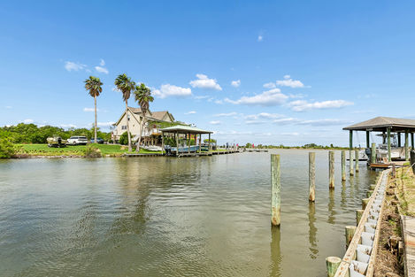 Home on the waterfront outside of New Orleans palm trees, boat slip