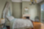 At Ease Soldier Sherwin Williams painted room in a New Orleans house with a canopy bed and single chair