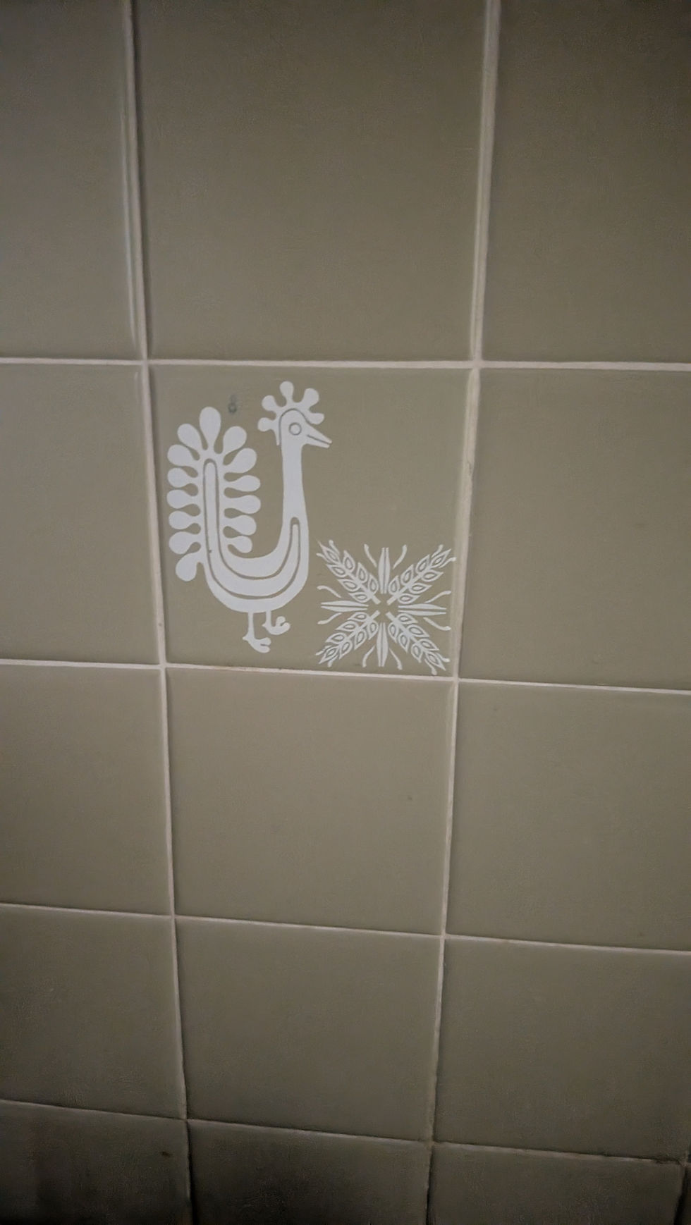 Retro mid century sage green avocado green tile with chicken stampled on it