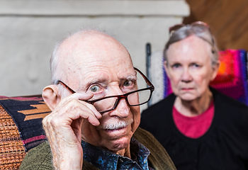 Old man and woman looking at the camera.
