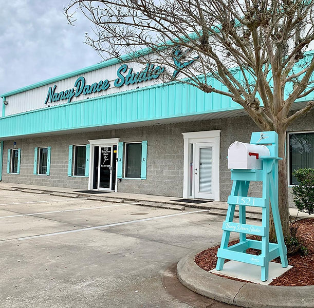 A lifeguard chair mailbox on the curb of a Jacksonville Beach dance studio business