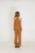 Frau mit elegantem Zweiteiler aus nachhaltigem Tencel in Goldbraun als Alternative zum Kleid, Rückansicht