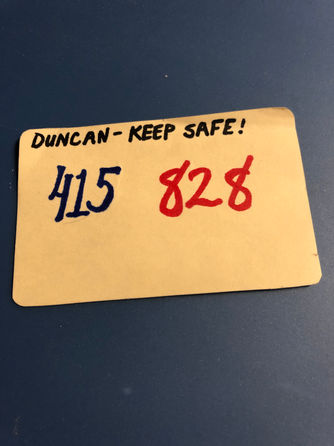 Small note card stating "Duncan-keep safe! 415 828", the code to the briefcase found in a wallet