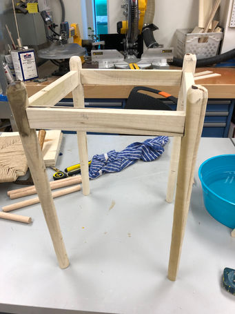 Basic frame with tapered legs and the apron of the stool