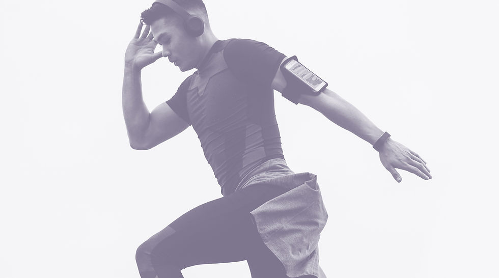 Image shows a person in motion with their right hand up towards the side of their head and the left arm outstretched backwards.